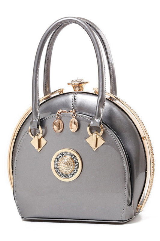 Gray handbag with gold accents on a white background