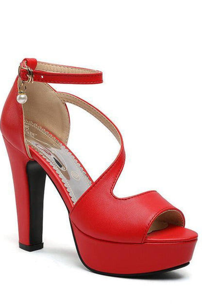 Red high-heeled sandal with a platform on a white background