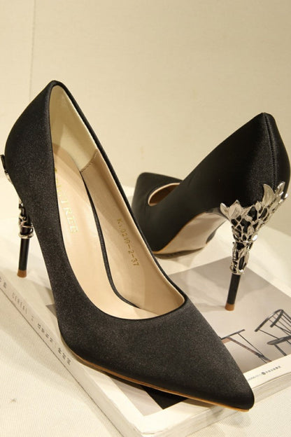 Black high-heeled shoes with decorative heel on a magazine