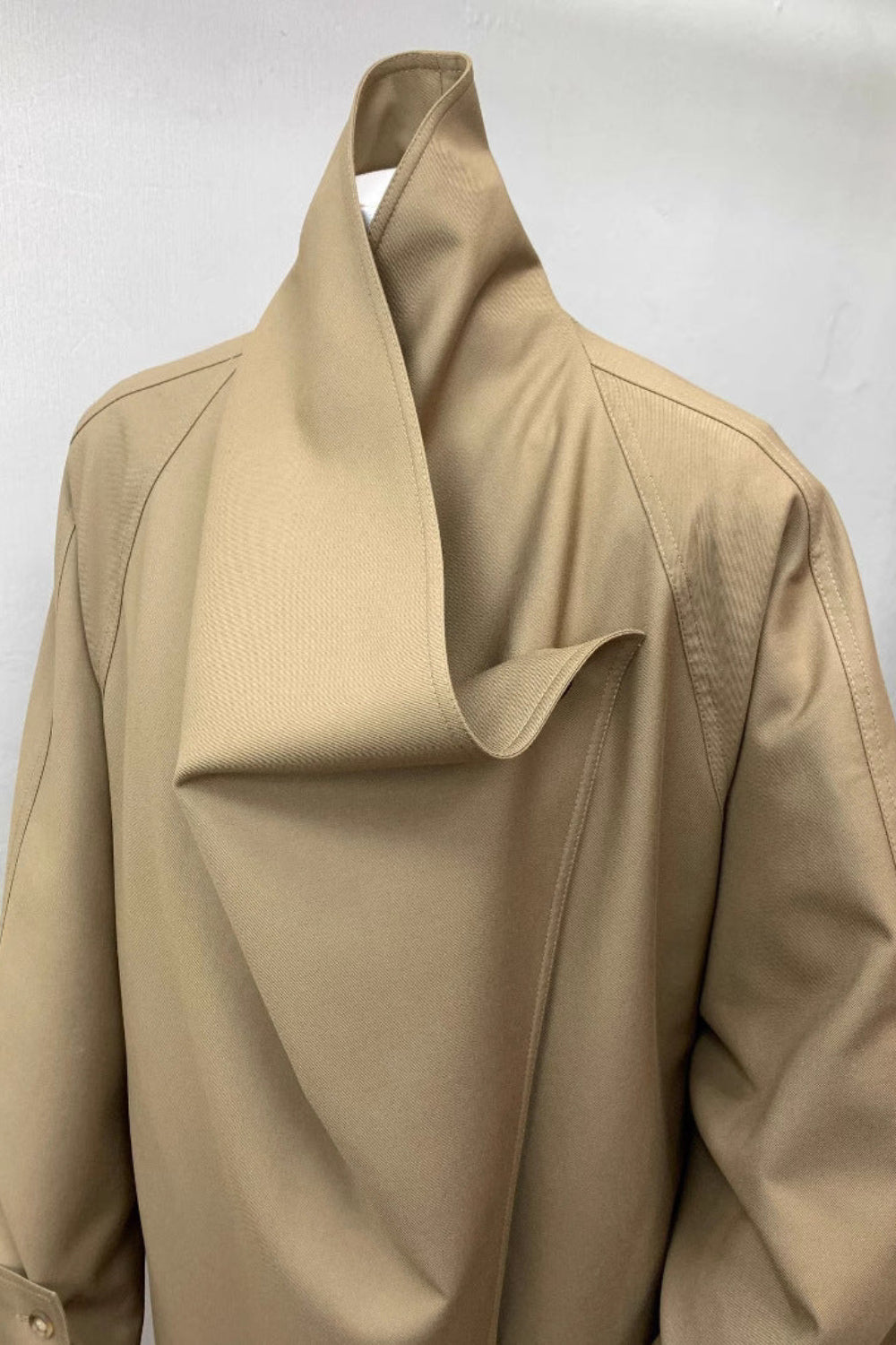 Beige trench coat on a white background