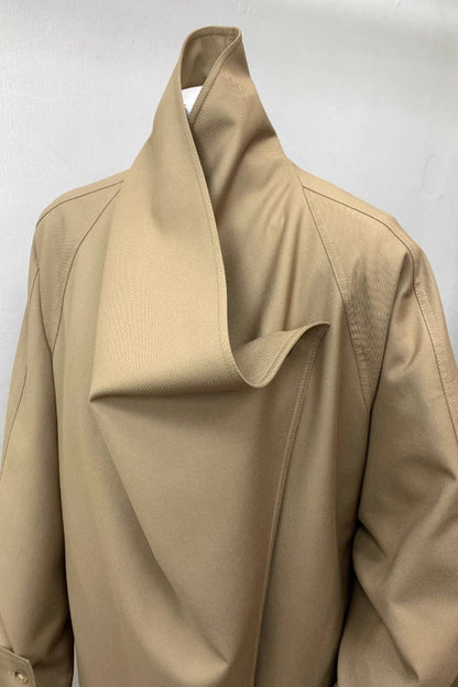 Beige trench coat on a white background