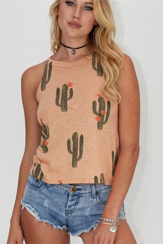 Woman wearing a sleeveless top with cactus pattern and denim shorts on a plain background