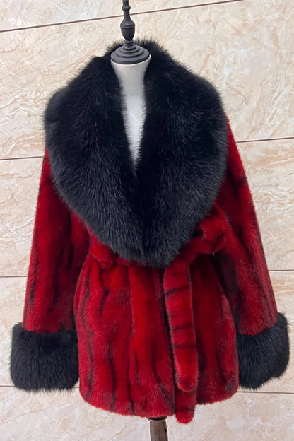 Red fur coat with black fur collar on a mannequin against a beige tiled wall.