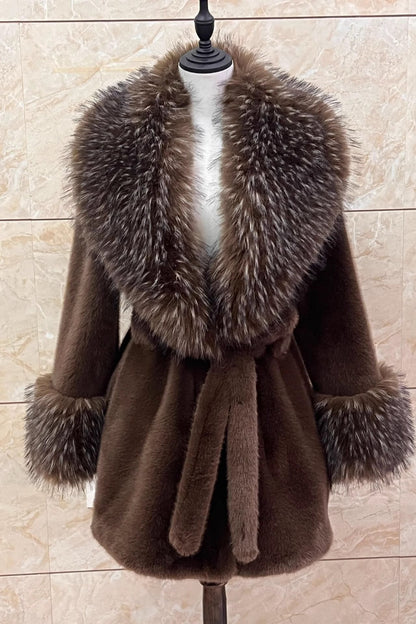 Brown coat with fur collar on a mannequin against a beige tiled wall.
