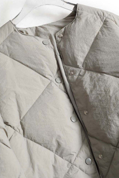 Light gray quilted jacket on a white background