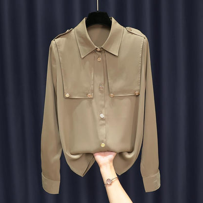 Beige shirt on a hanger against a dark background