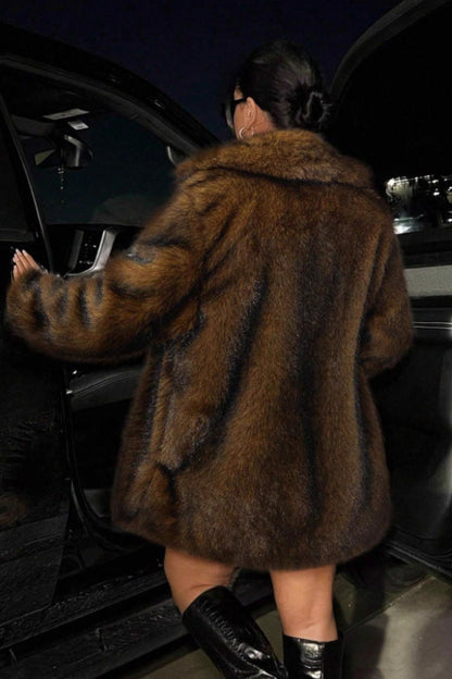 Person in a fur coat getting into a car at night