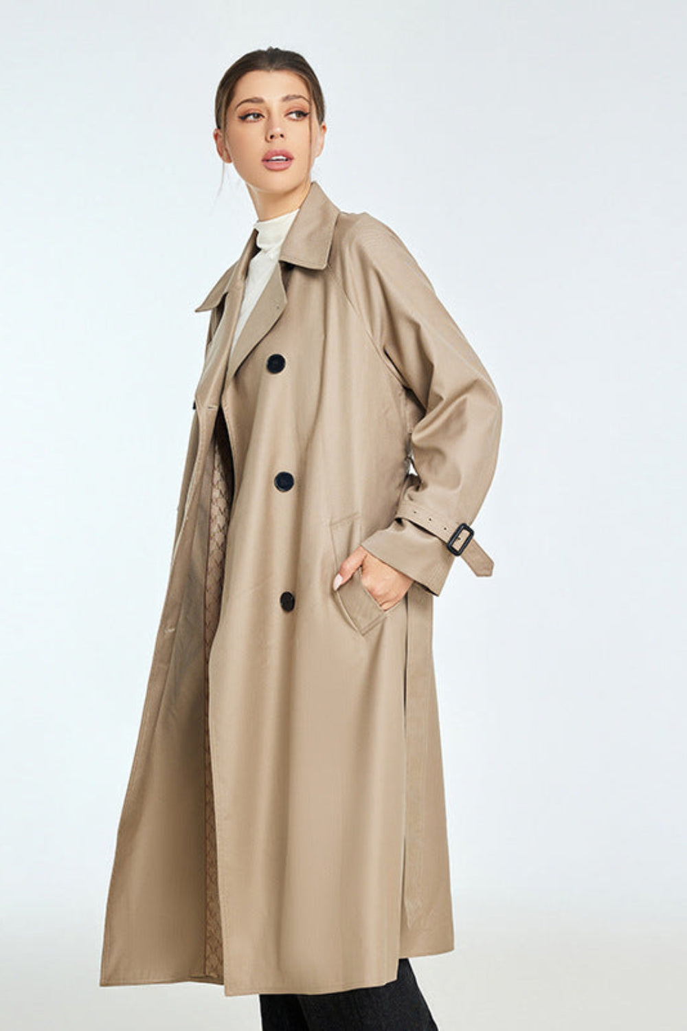 Woman wearing a beige trench coat on a white background