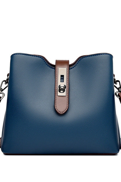 Blue handbag with brown straps on a white background