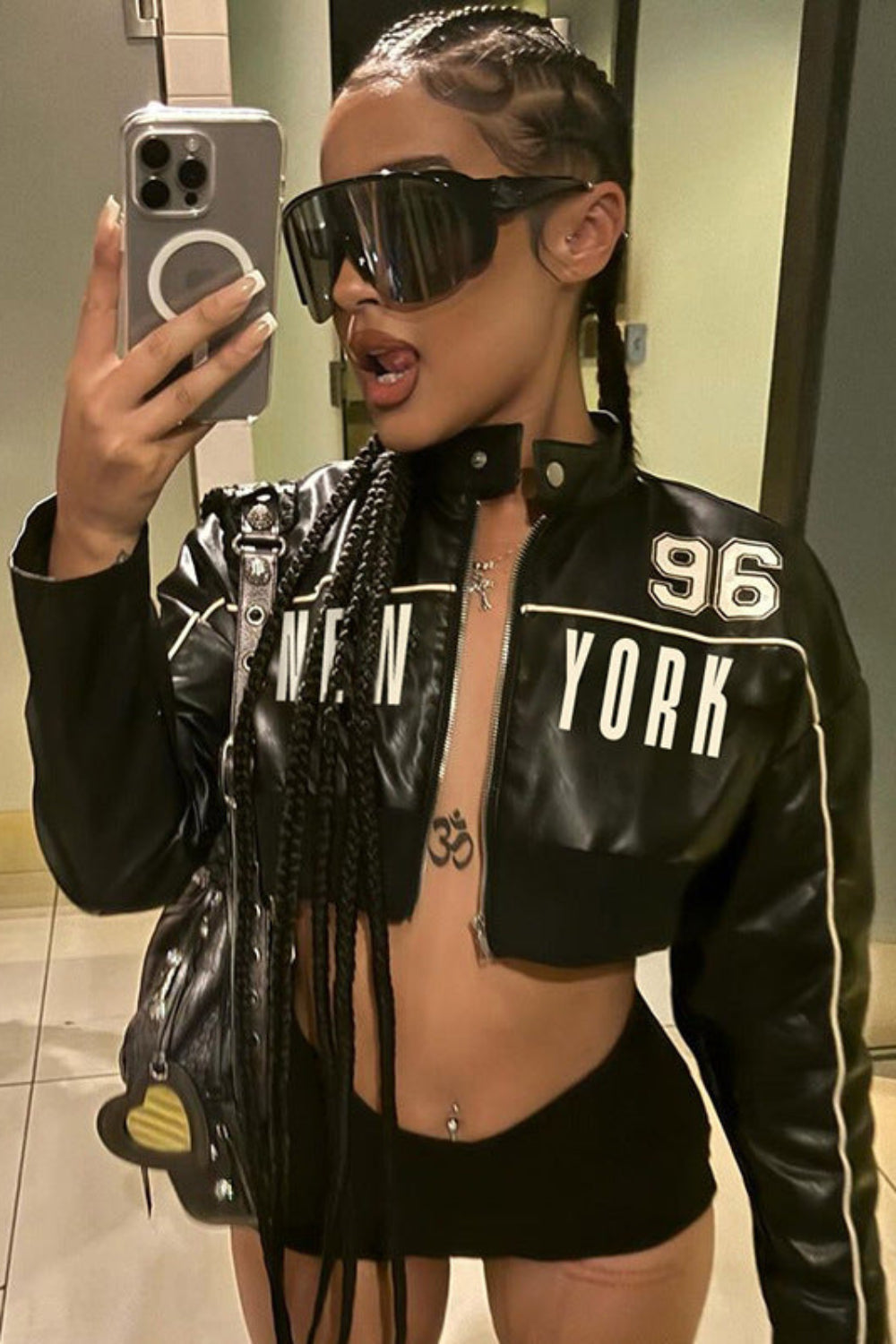 Person wearing a black '96 York' jacket taking a mirror selfie.