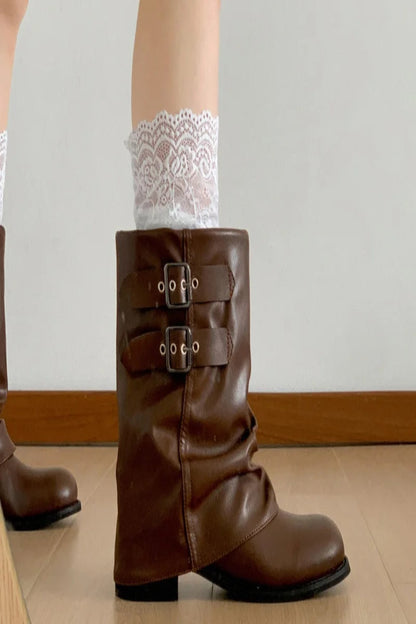 Brown leather boot with buckles worn with white lace socks on a neutral background