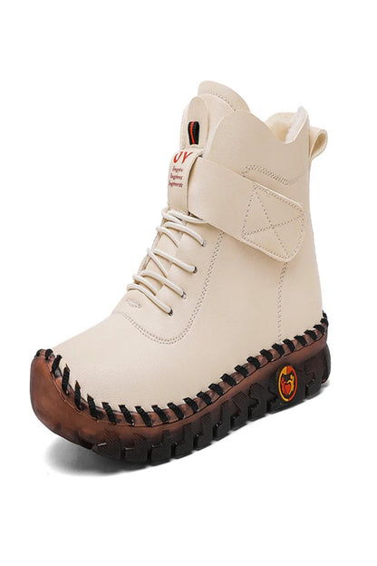Beige high-top boot with brown sole on a white background