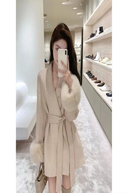 Person wearing a beige coat with fur trim in a store setting