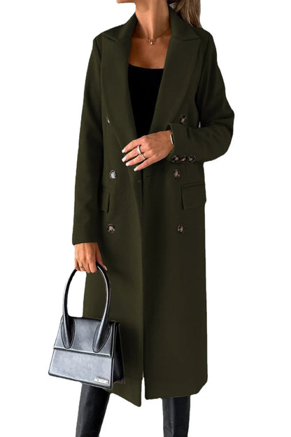 Person wearing a long olive green coat holding a black handbag on a white background