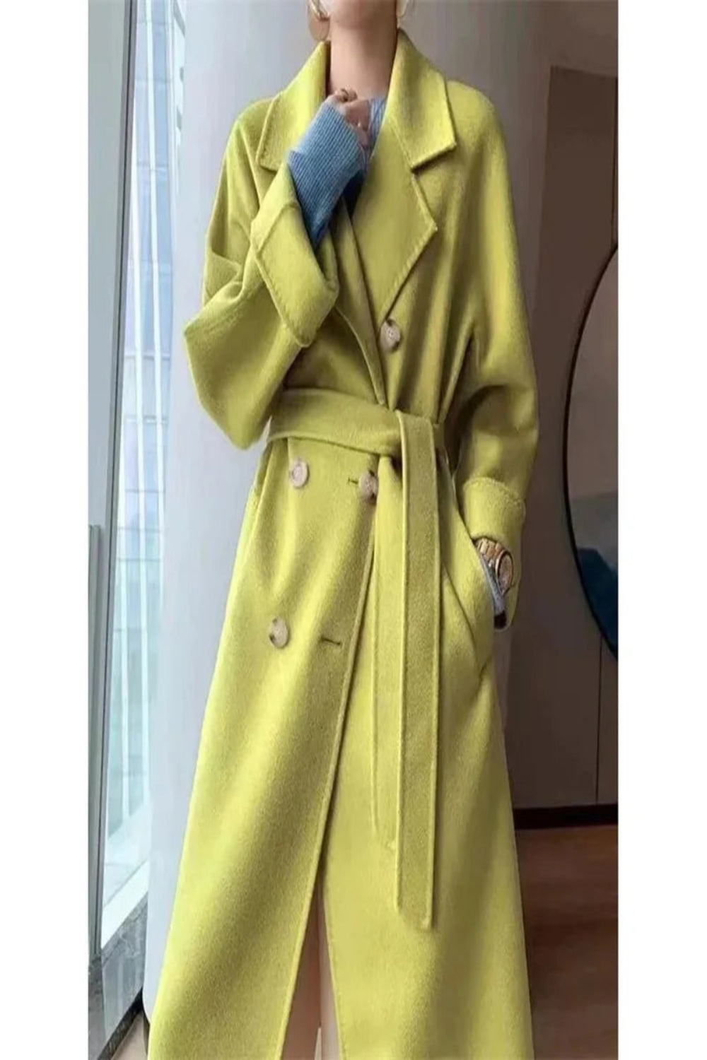 Person wearing a bright yellow coat indoors