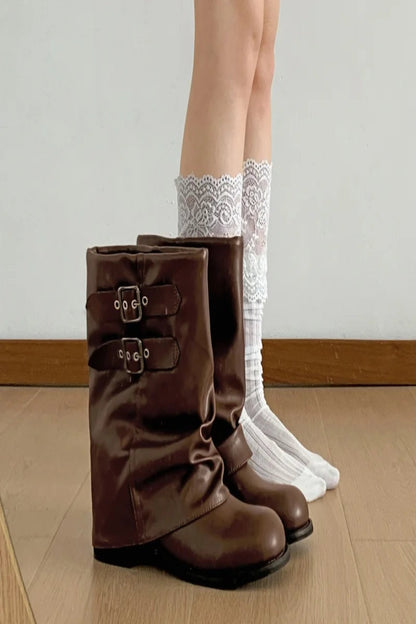 Brown knee-high boots with white lace socks on a wooden floor.