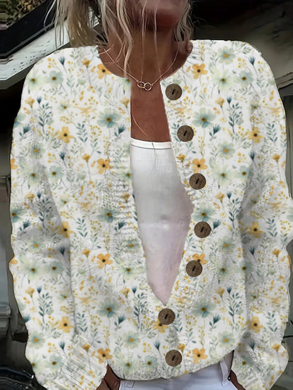 Floral cardigan with button details worn by a person, with a blurred background.
