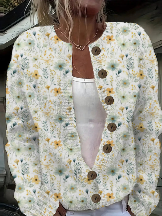 Floral cardigan with button details worn by a person, with a blurred background.