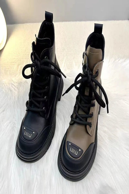 Pair of black and brown boots with 'UILU' branding on a white surface.