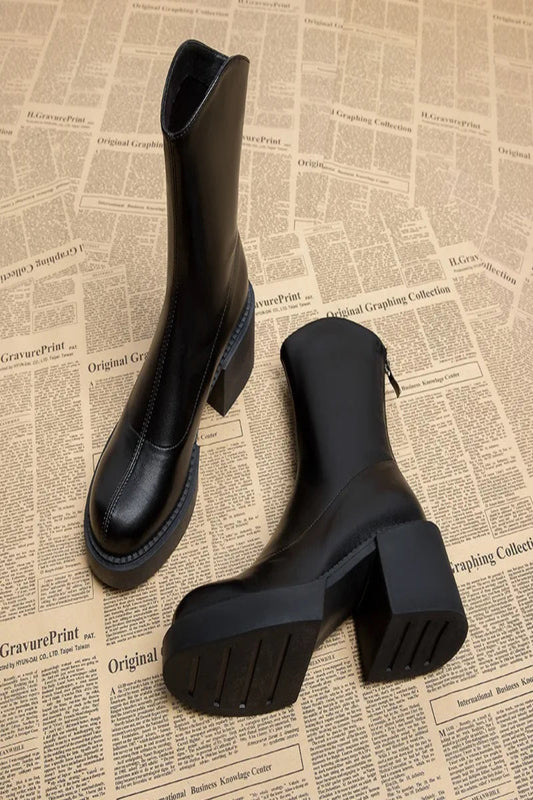 Black boots on a newspaper background