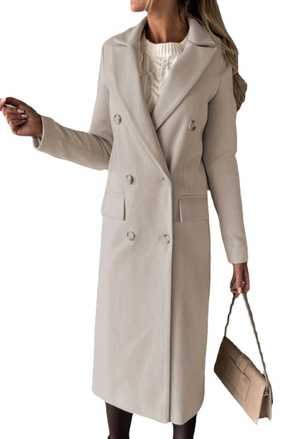 Woman wearing a beige coat holding a matching handbag on a white background