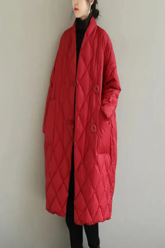 Person wearing a red quilted coat against a plain background