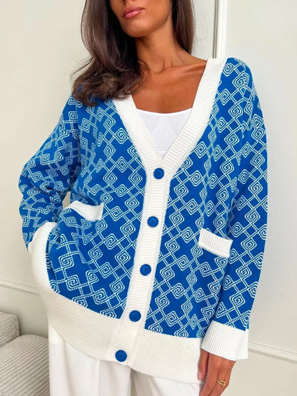 Woman wearing a blue and white patterned cardigan with a white shirt underneath.