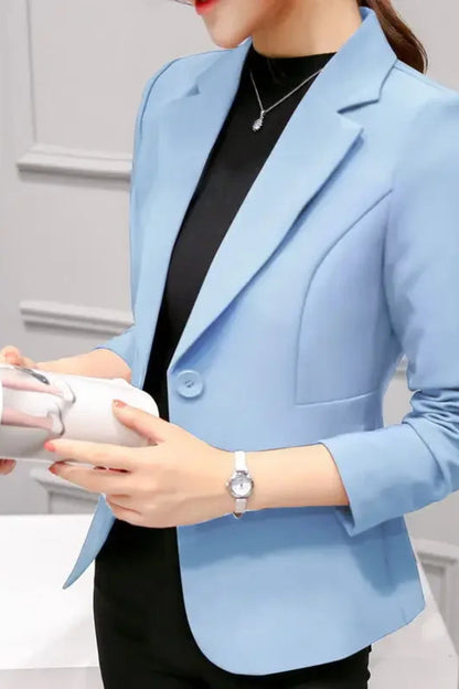 Light blue blazer worn by a person against a neutral background