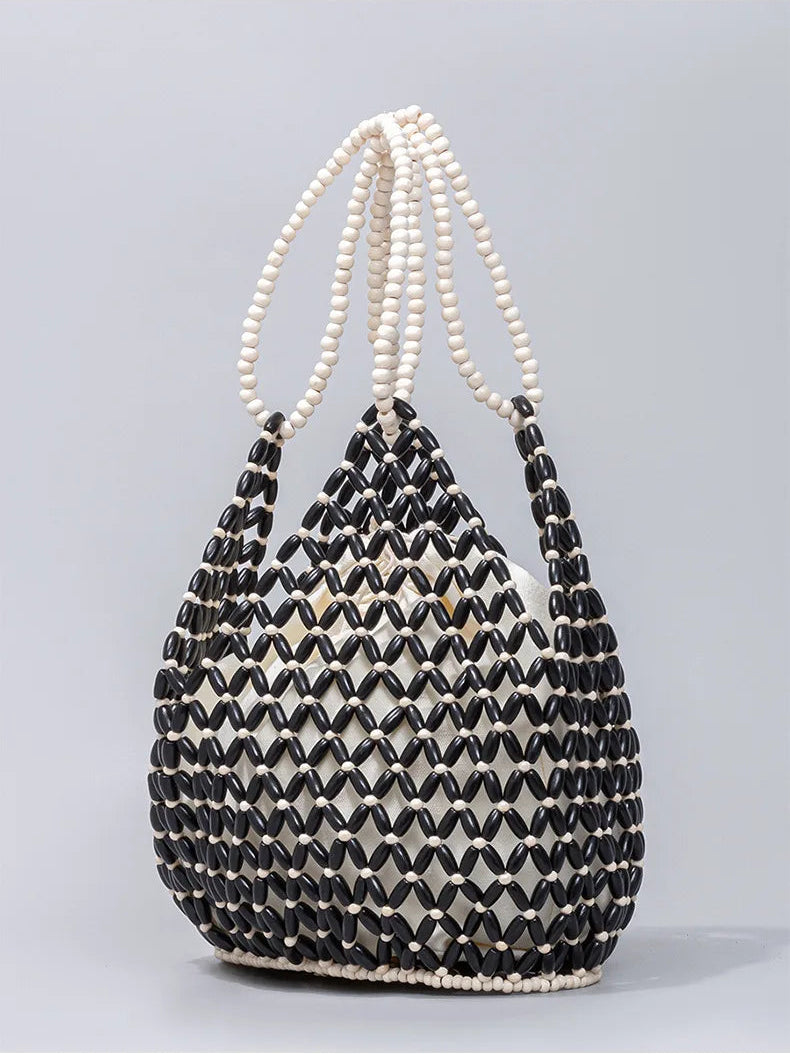 Black and white beaded handbag on a gray background