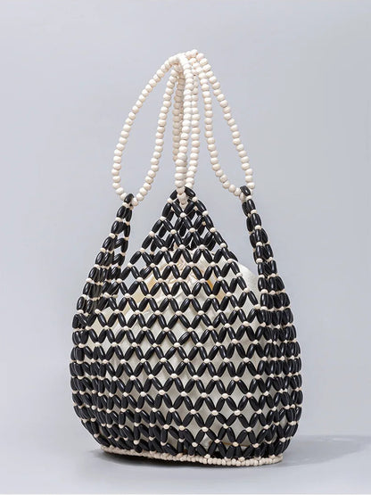 Black and white beaded handbag on a gray background