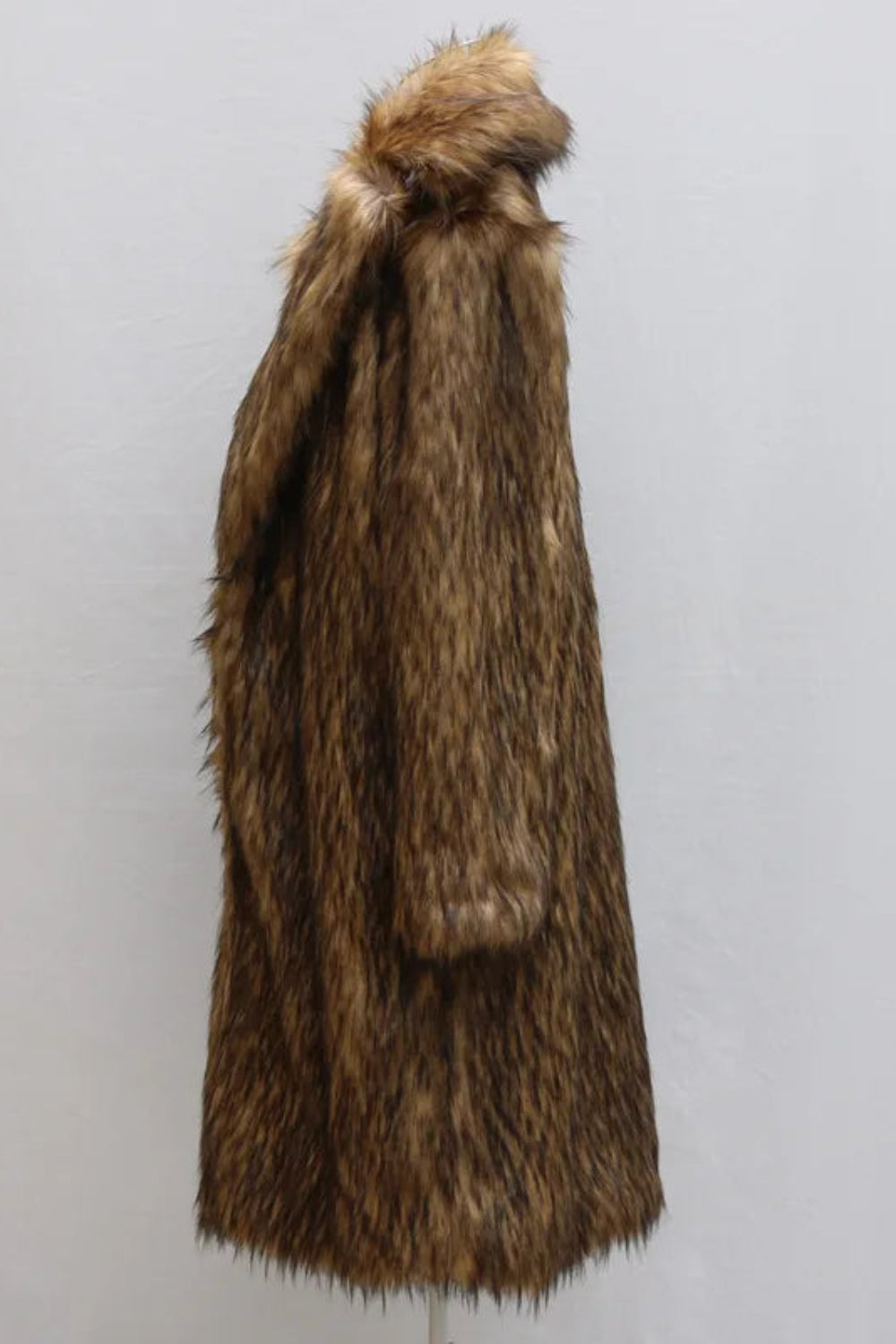 Brown fur coat with a hood on a light gray background