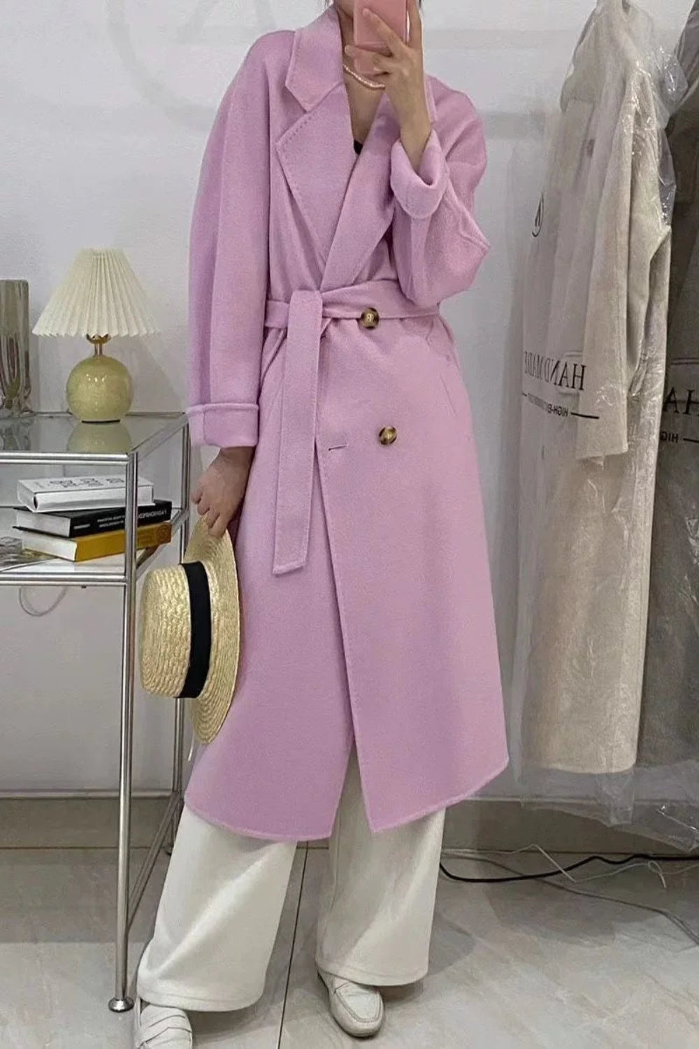 Person wearing a pink coat in an indoor setting