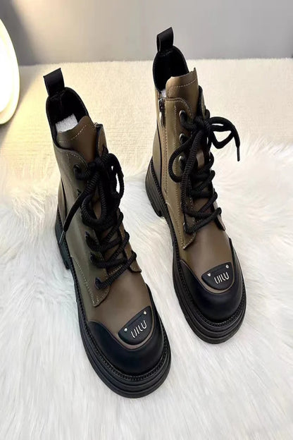 Pair of brown and black boots with a visible brand logo on a white surface.