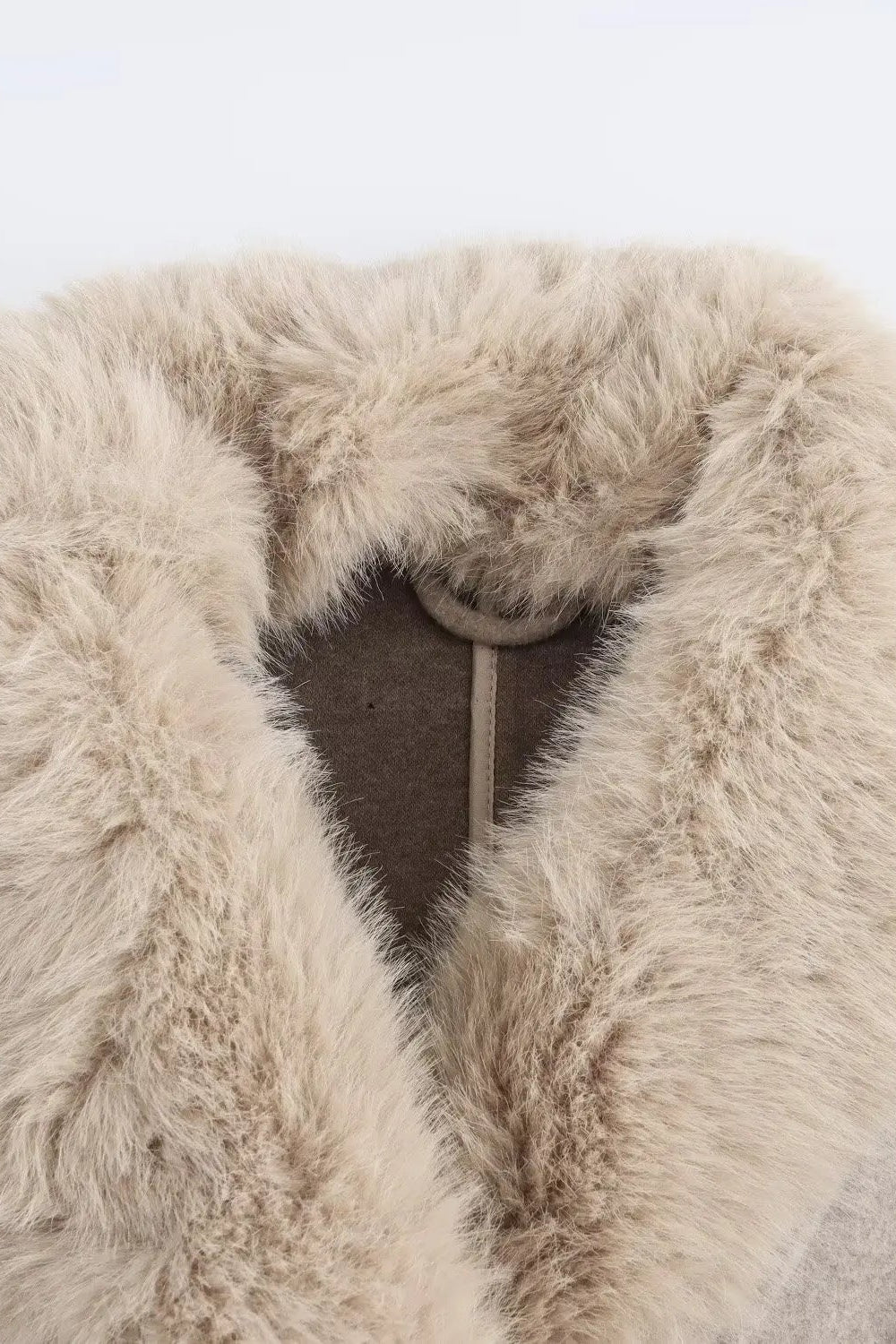 Close-up of a fur collar on a light gray background