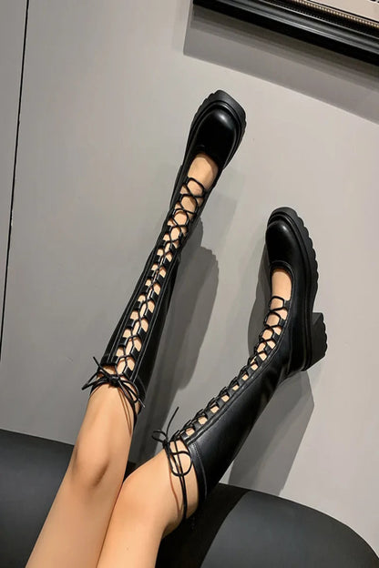 Black lace-up high-heeled shoes on a neutral background