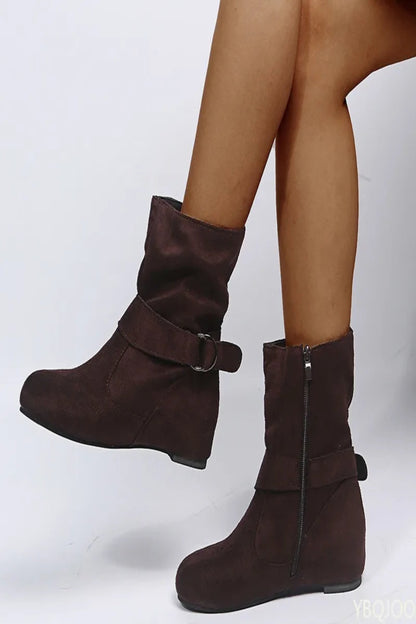 Brown ankle boots with buckles on a white background