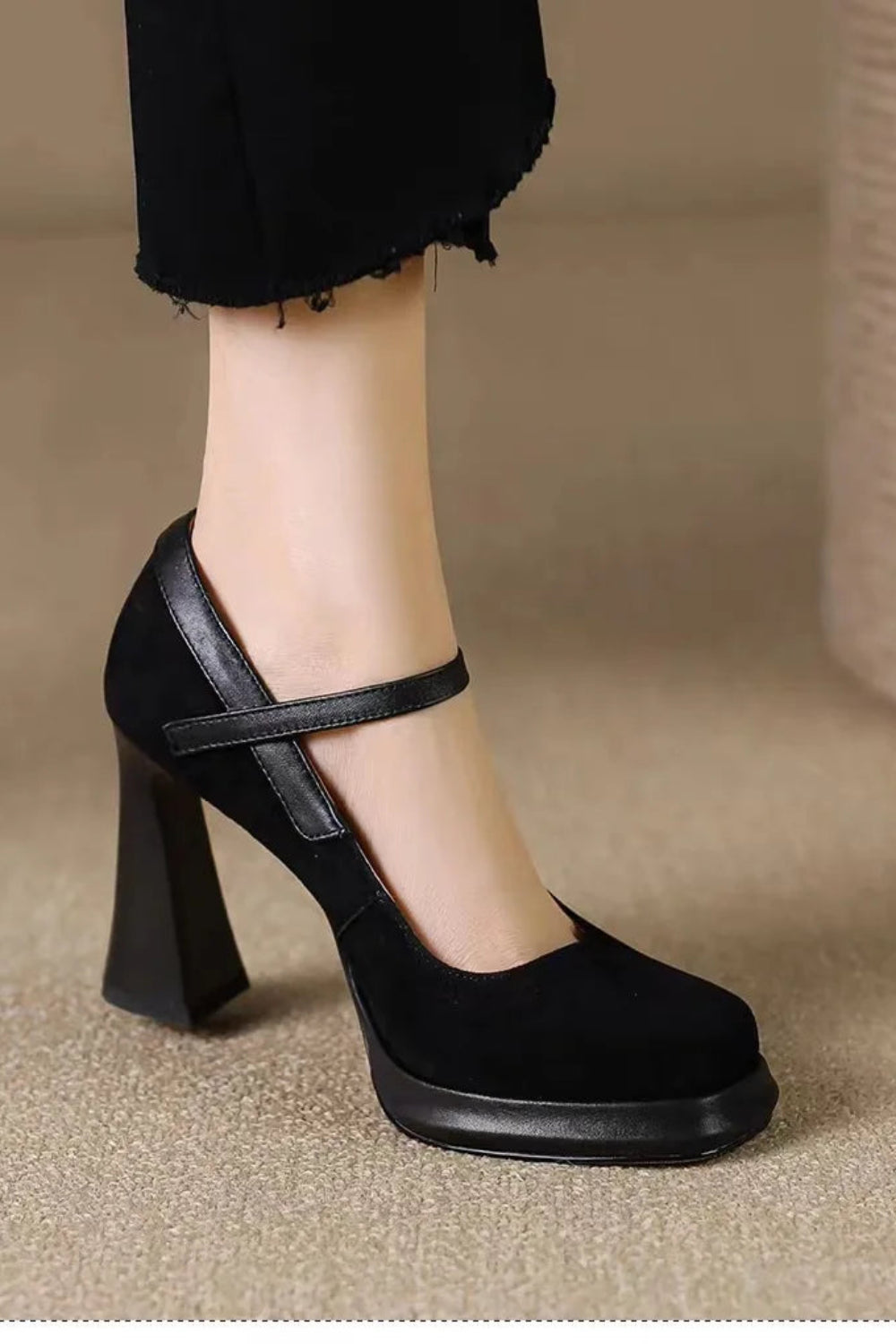 Black high-heeled shoe worn on a blurred background