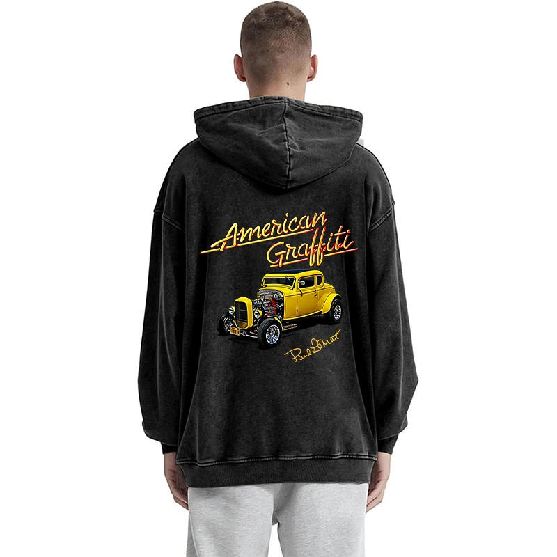 Person wearing a black hoodie with 'American Graffiti' design on the back, featuring a yellow car.