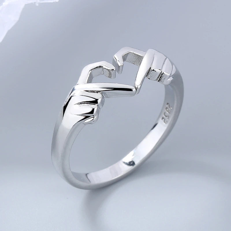 Silver ring with a unique design on a light gray background