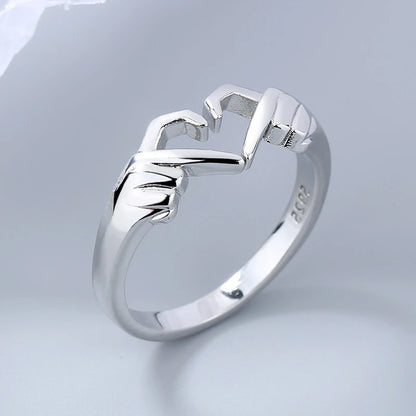Silver ring with a unique design on a light gray background