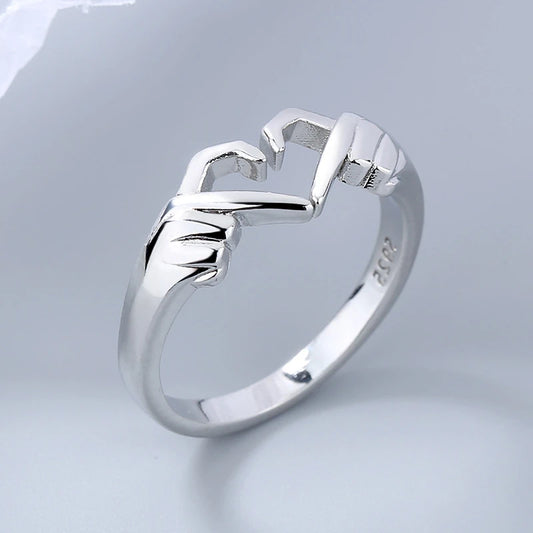 Silver ring with a unique design on a light gray background