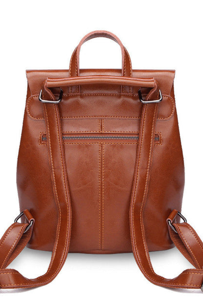 Brown leather backpack on a white background