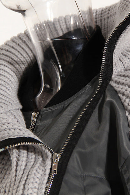 Gray knit cardigan with a black interior lining on a mannequin against a white background