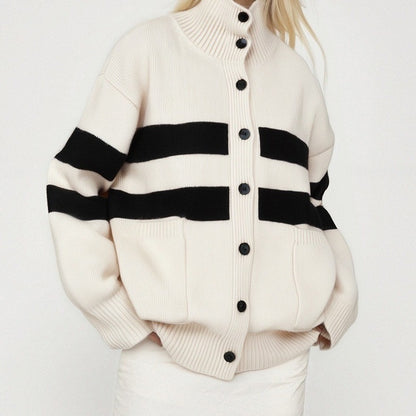 White cardigan with black stripes and buttons on a white background