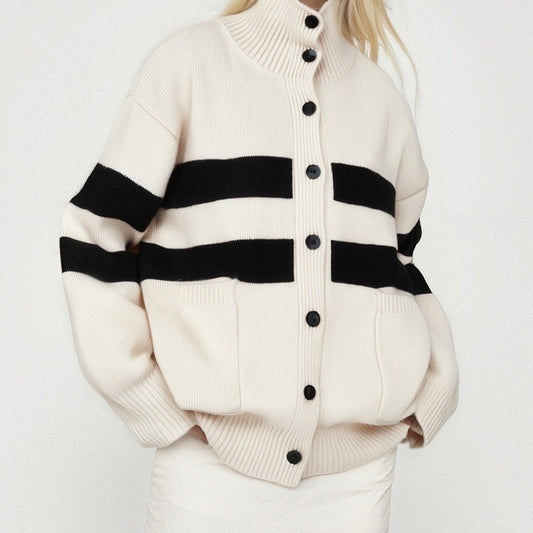 White cardigan with black stripes and buttons on a white background