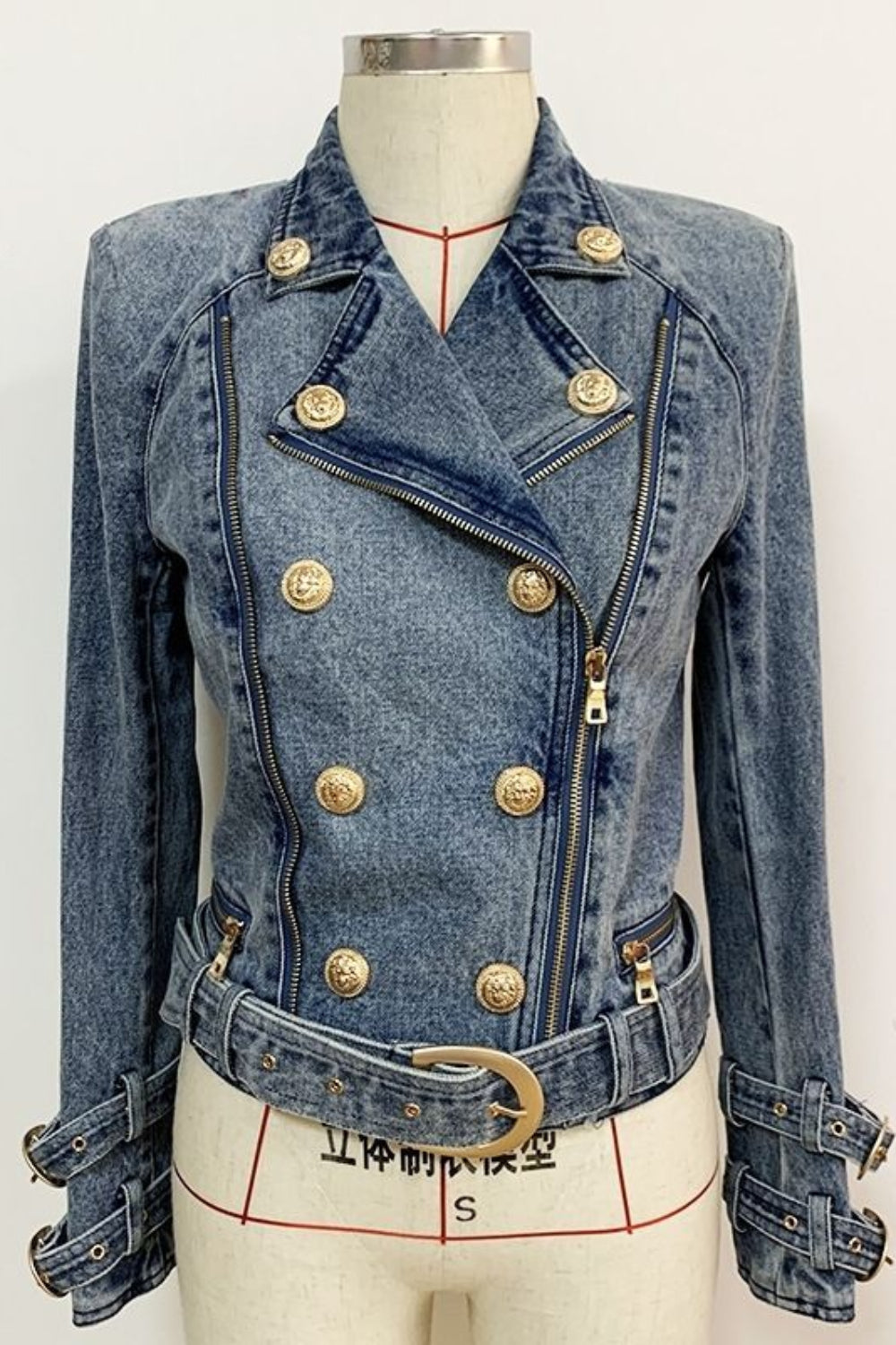 Denim jacket with gold buttons on a mannequin against a white background
