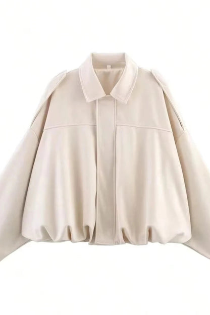 Beige cape-style jacket on a white background