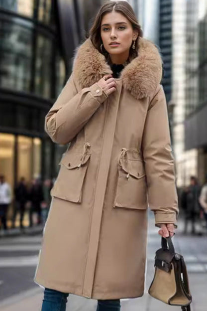 Woman wearing a beige coat with a fur collar in an urban setting