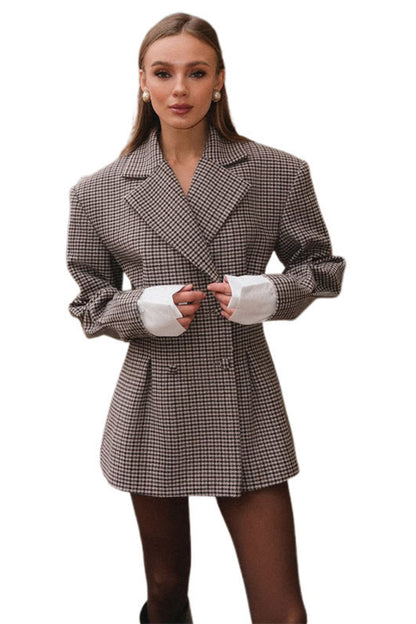 Woman wearing a checkered coat on a white background