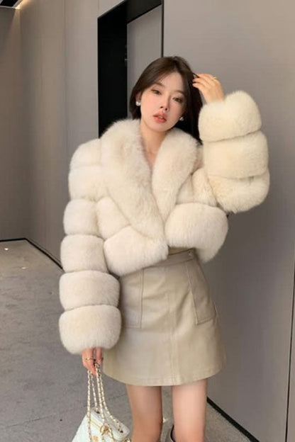 Woman wearing a white fur coat in an indoor setting